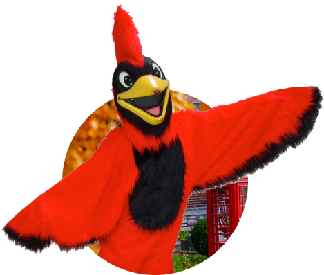 Billy J. Bird, the William Jewell College mascot, posing with wings spread open, framed in a circular cutout with campus trees and a red phone booth in the background.