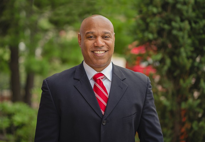 Headshot of William Palmer, Director of Student Recruitment at William Jewell College, wearing a suit and red striped tie.