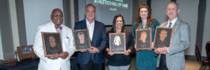 5 inductees holding plaque awards at the William Jewell Athletics Hall of Fame ceremony.