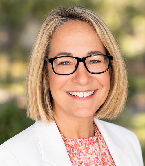 Headshot of a woman wearing glasses.