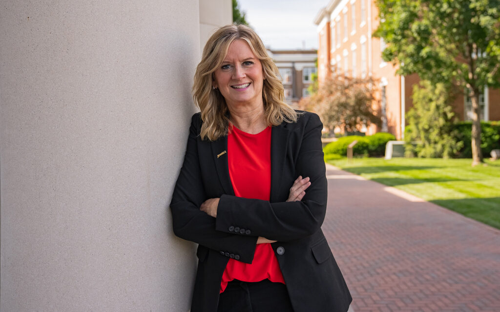 Headshot of Julie McGovern, Chief Financial Officer at William Jewell College, wearing a black blazer and red top.