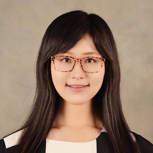 Headshot of Ge Zhu, Assistant Professor of Communication at William Jewell College, wearing glasses and a black and white top against a neutral backdrop.