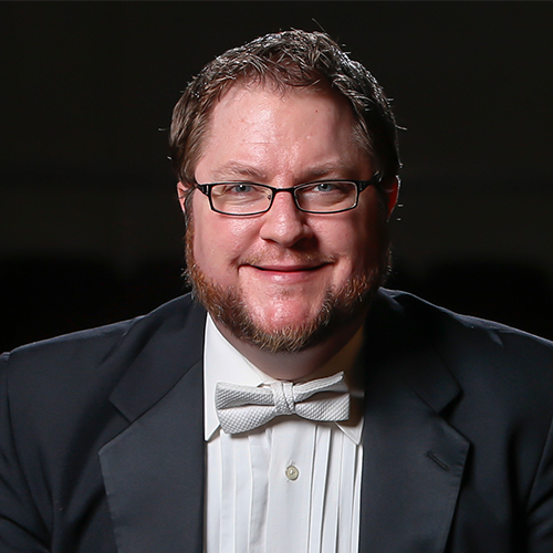 Headshot of Dr. Langston Hemenway, Associate Professor of Music and Director of Instrumental Studies at William Jewell College, wearing glasses and a formal tuxedo with a white bow tie.