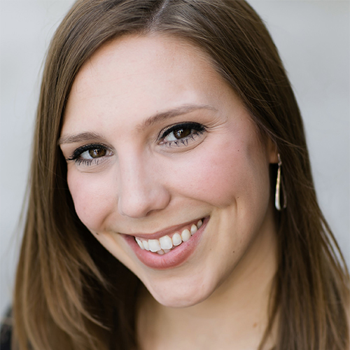 Headshot of Laura Lowry, Director of Undergraduate Vocal Studies at William Jewell College, smiling with long light brown hair and silver drop earrings.