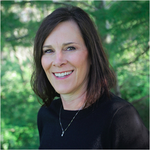 Headshot of Michele Peck, Adjunct Instructor of Education at William Jewell College, smiling in a black top with a green leafy outdoor background.