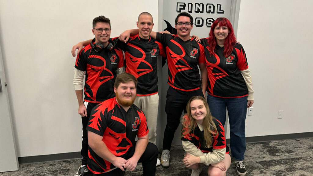 6 members of the Esports Overwatch team posing together in black and red team jerseys.