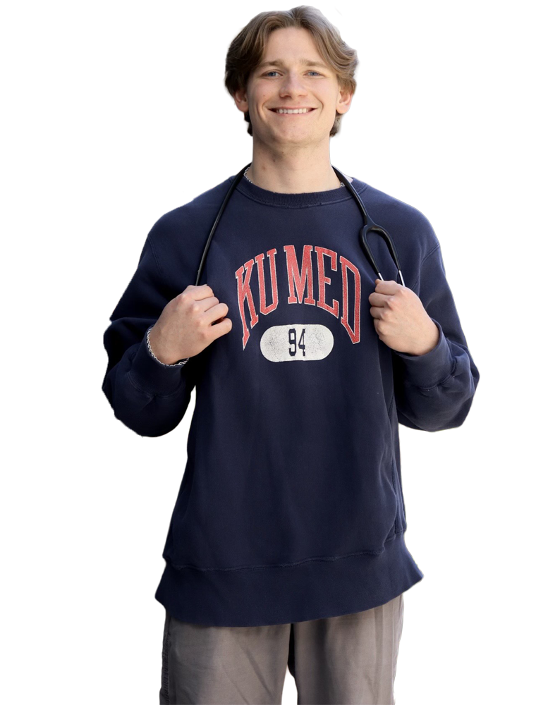 Carson Krop smiling in a navy KU Med sweatshirt with a stethoscope draped around his neck.