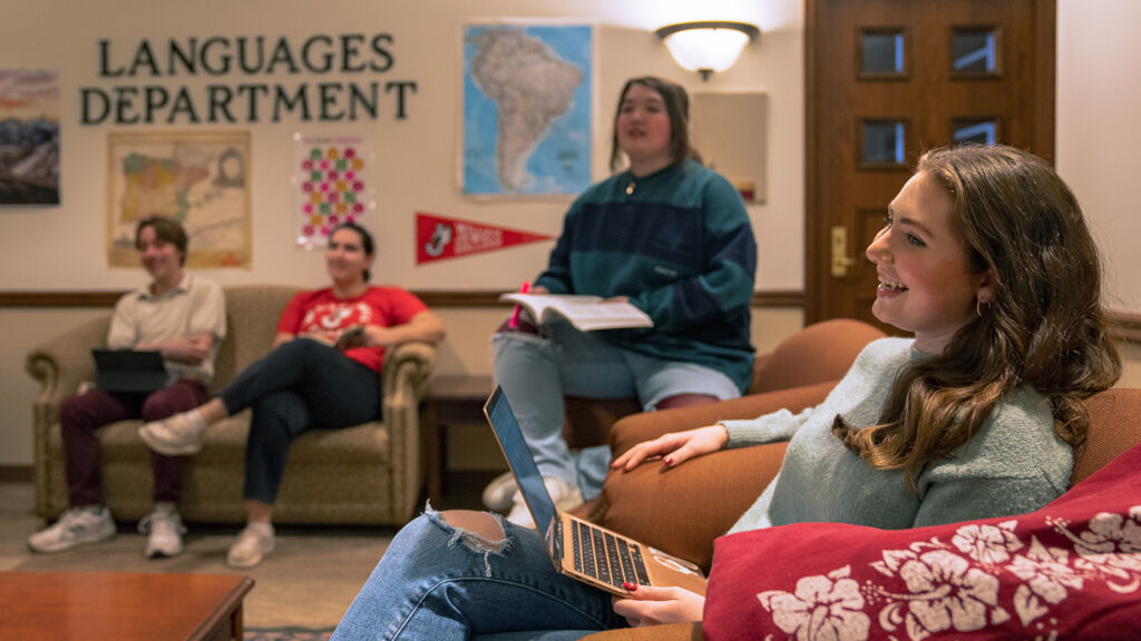 Students studying together on couches in the Languages Department lounge.