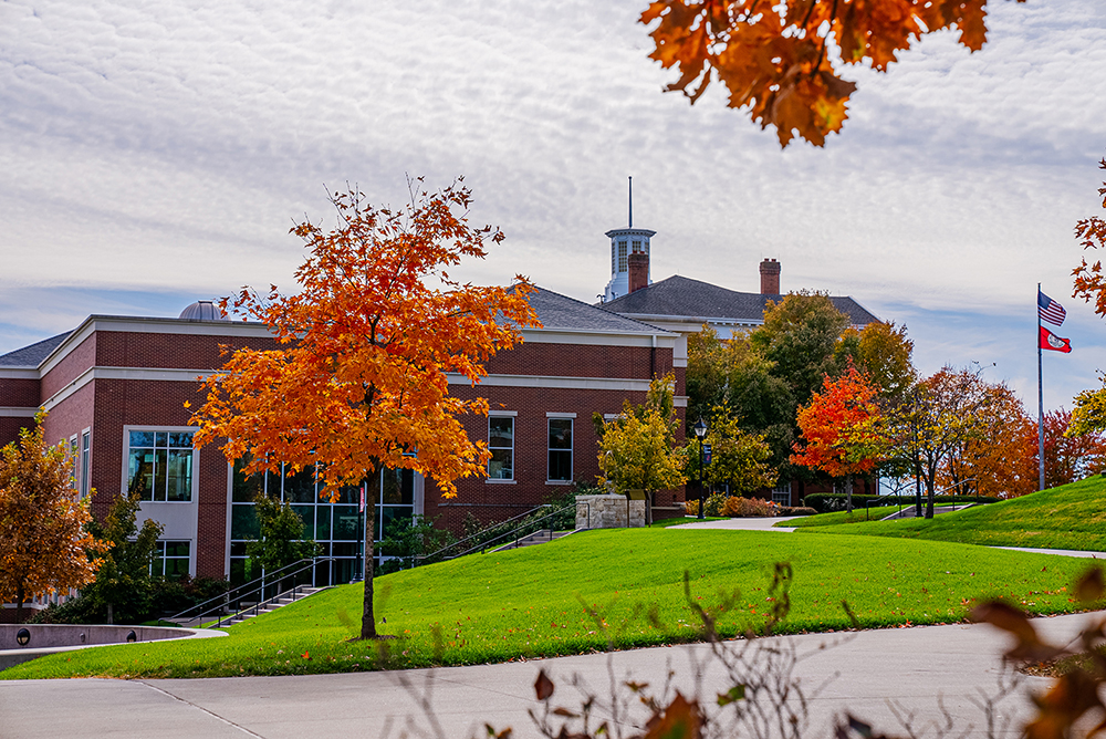 Pryor Learning Commons and the campus quad framed by vibrant autumn trees.