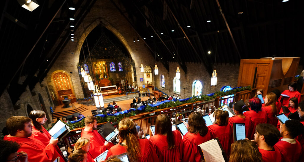 Members of the William Jewell Concert Choir performing from a balcony in a cathedral.