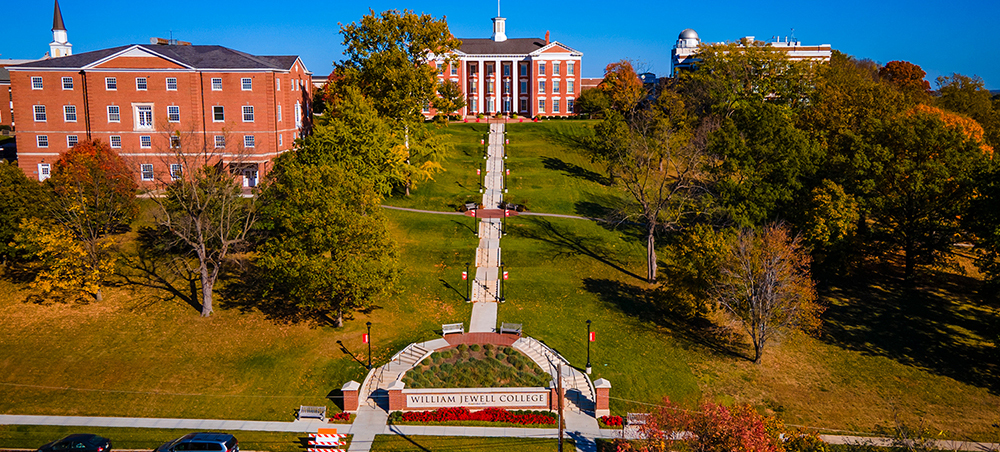 Aerial view of campus featuring Jewell Hall, Curry Hall, and the central Quad staircase.