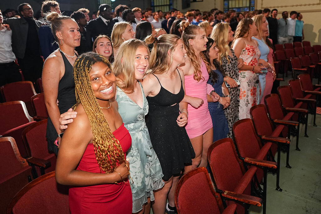 A group of student-athletes smiling and standing together in an auditorium during the annual JESPY Awards ceremony.