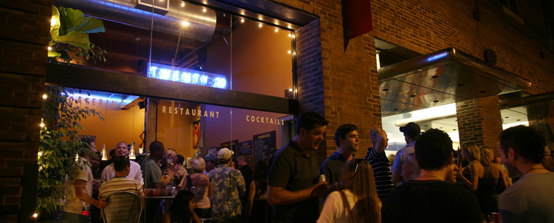 people standing in outdoor restaurant space