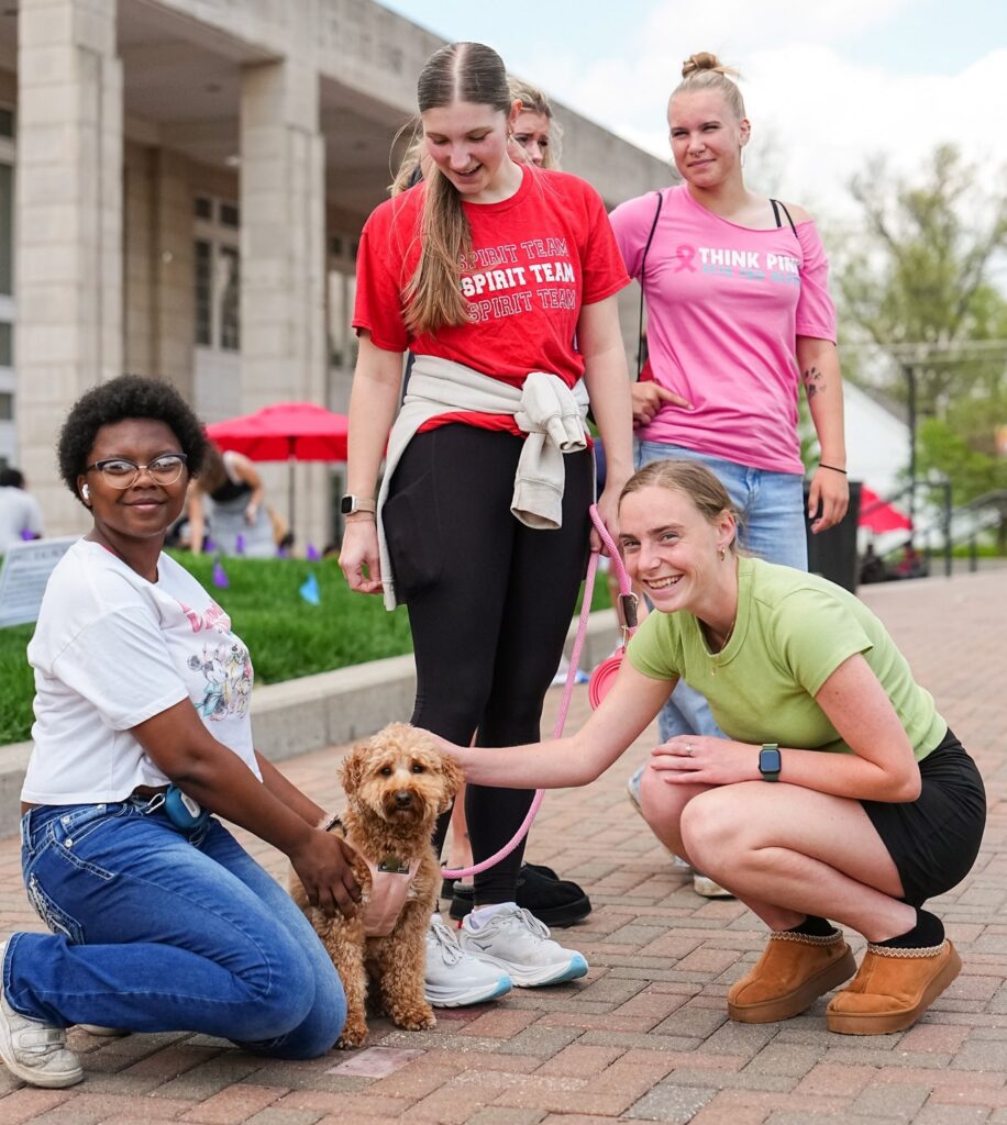 Group gathers to pet dog
