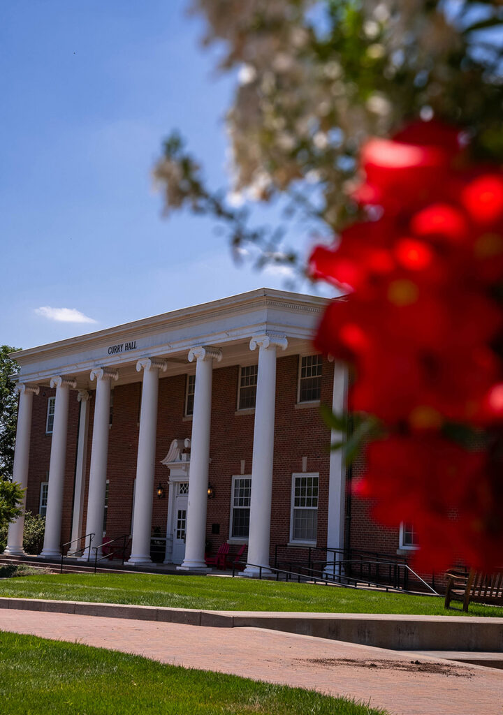 Outside of Curry Hall with summer flowers blooming