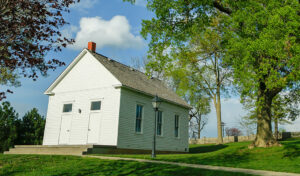 Outside of old white schoolhouse on Jewelll campus