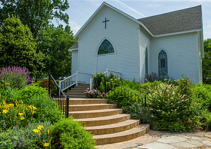 Grand River Chapel exterior and flowers around rock staircase entrance
