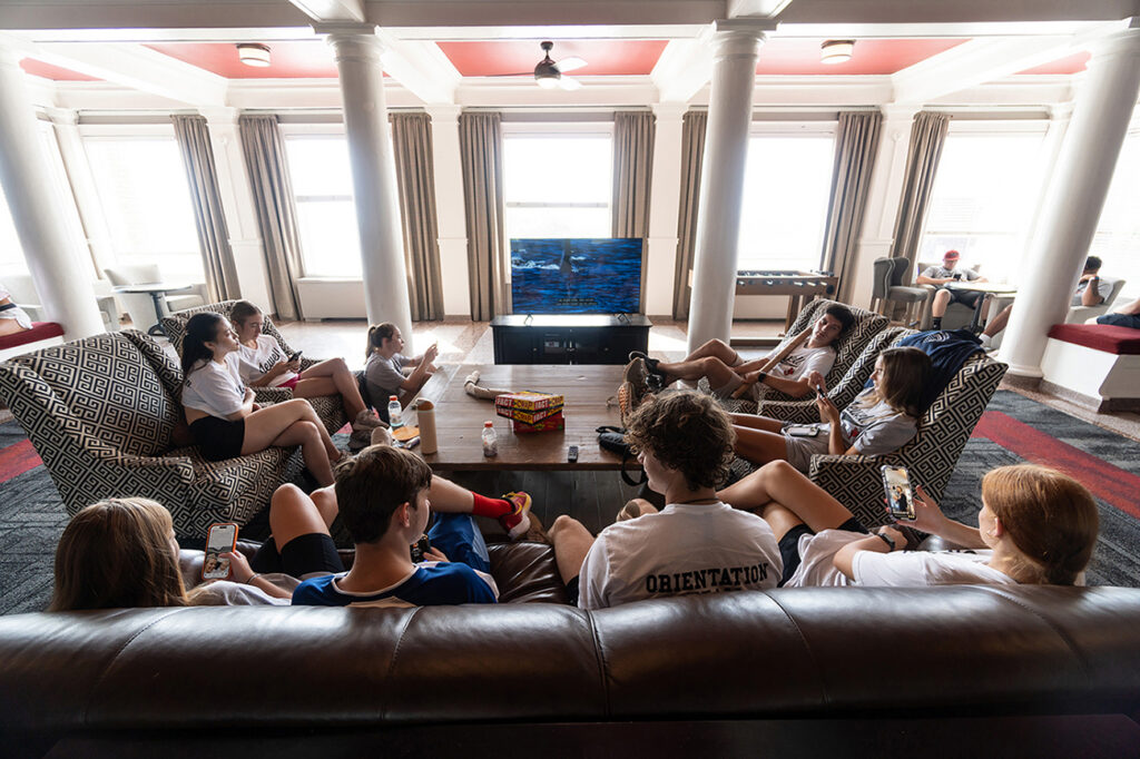 students sitting in Mathes Hall lobby