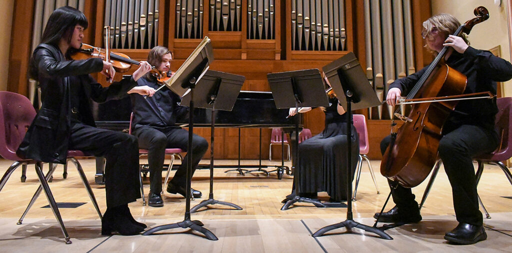 small ensemble playing stringed instruments on Chapel stage