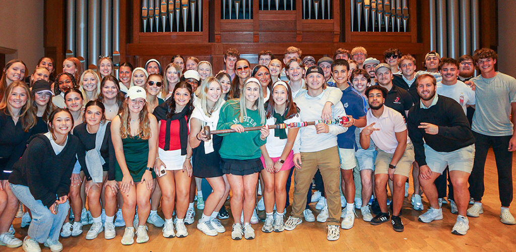 Greek members posing on stage after homecoming talent show