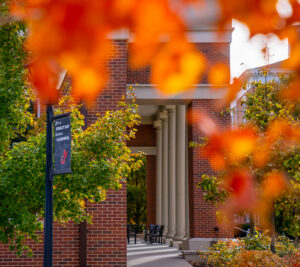 columns of Learning Commons behind autumn trees