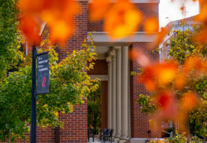 columns of Learning Commons behind autumn trees