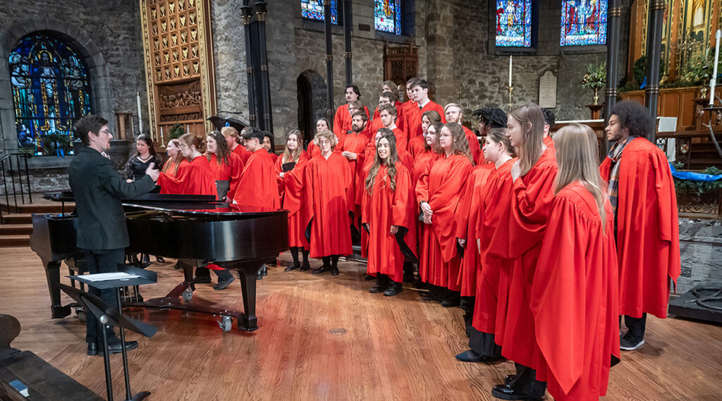 concert choir performing in front of large cathedral