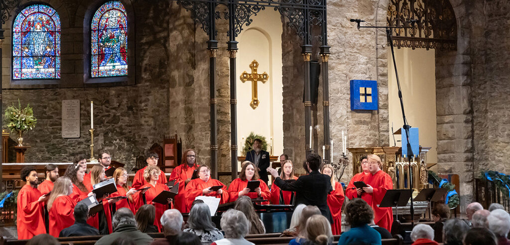 Concert choir singing in front of church for holiday service