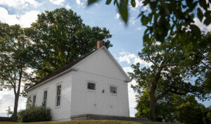 exterior of old schoolhouse on campus