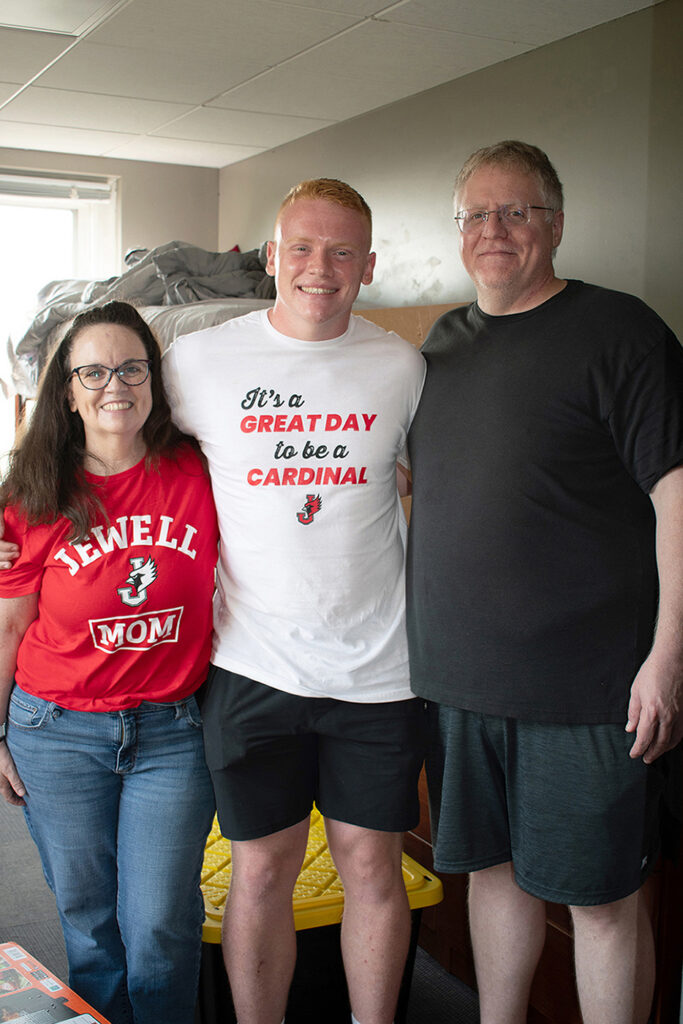 new student with his parents in residence hall room