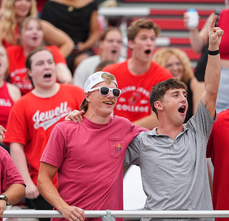 students cheering in football stadium