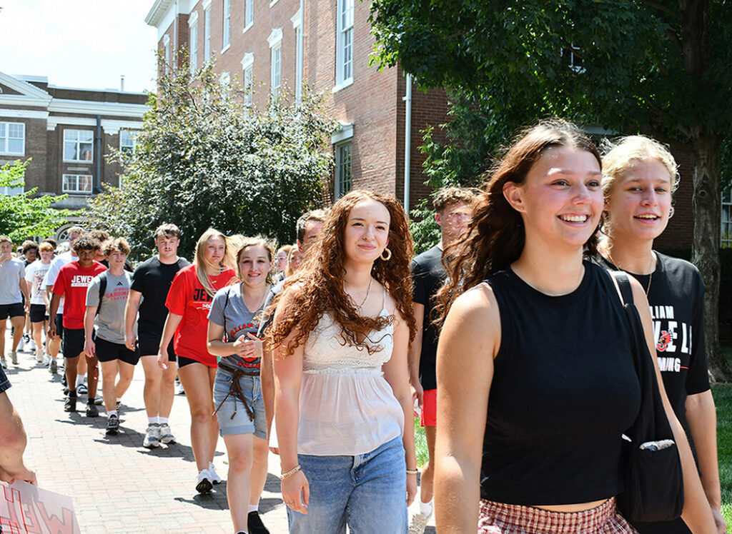 line of freshman walking around the quad during orientation ceremony