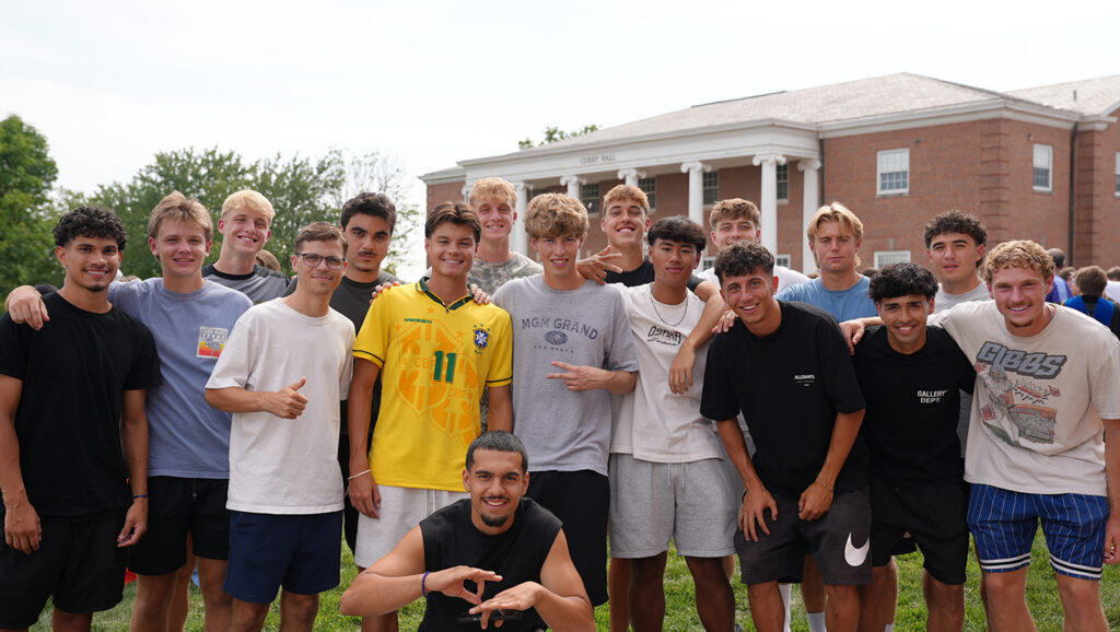 group of freshmen men posing outside