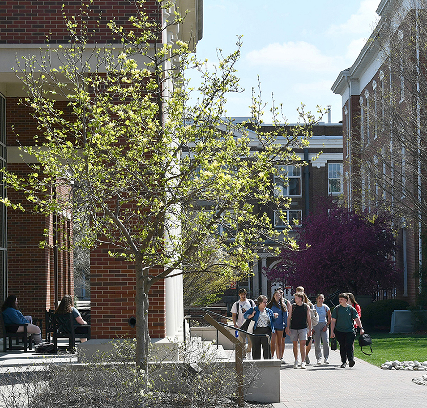 group of students walking outside with professor