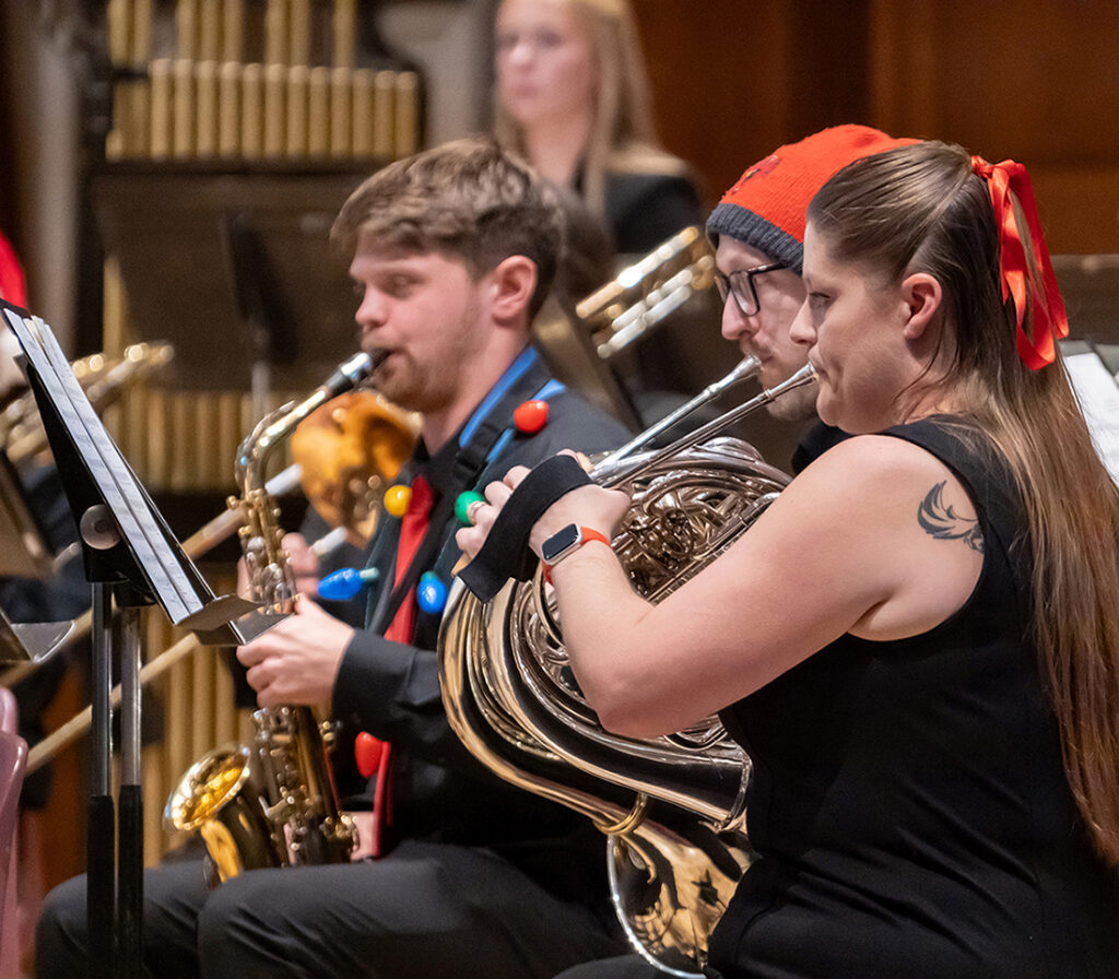 jazz band members playing horns on stage