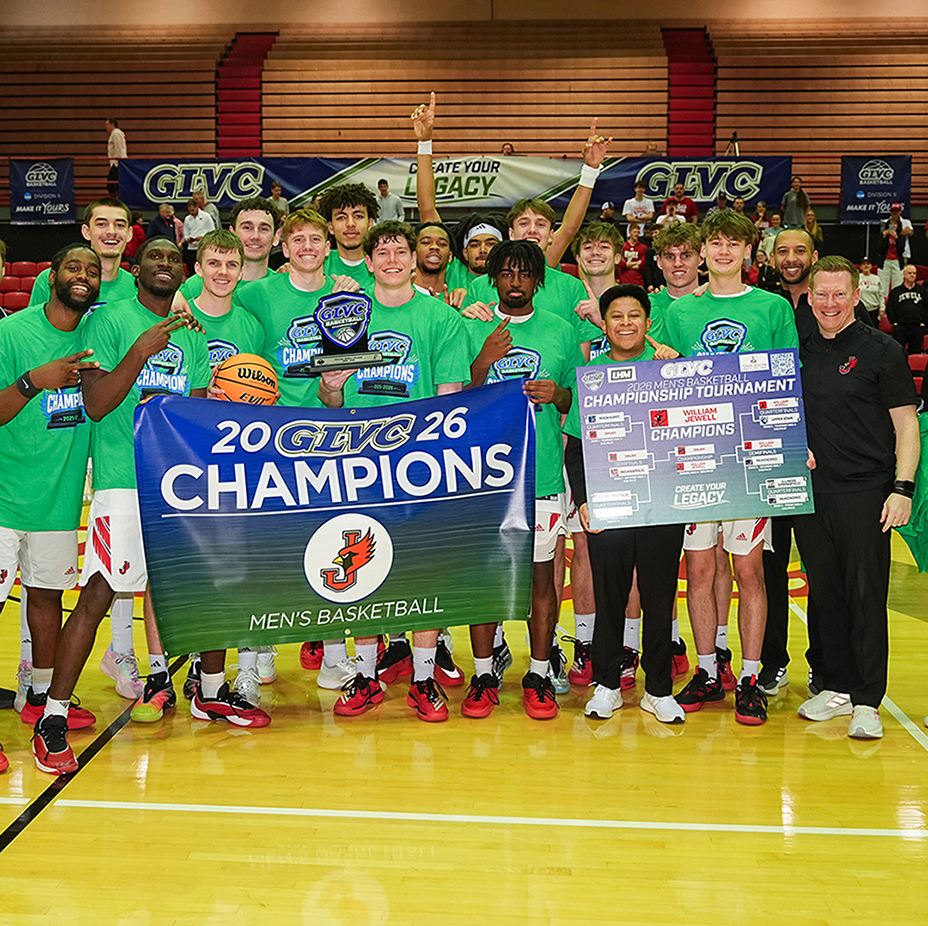 men's basketball team cheering holding conference champion banner after game