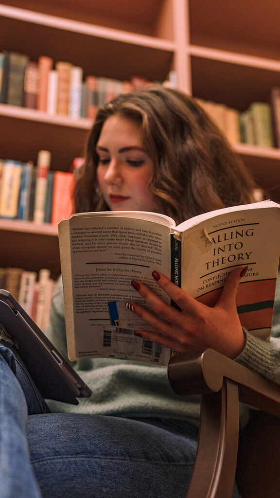 student reading book in library