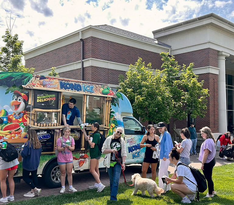 students outside gathered around Kona Ice food truck