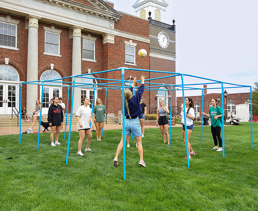 students playing 9-square outside on quad