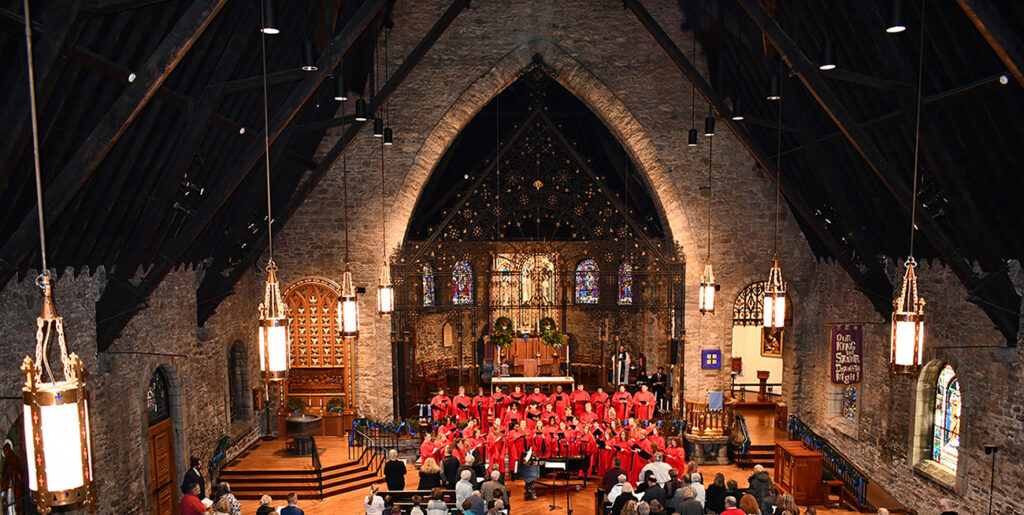 Jewell choir in red robes singing in large cathedral