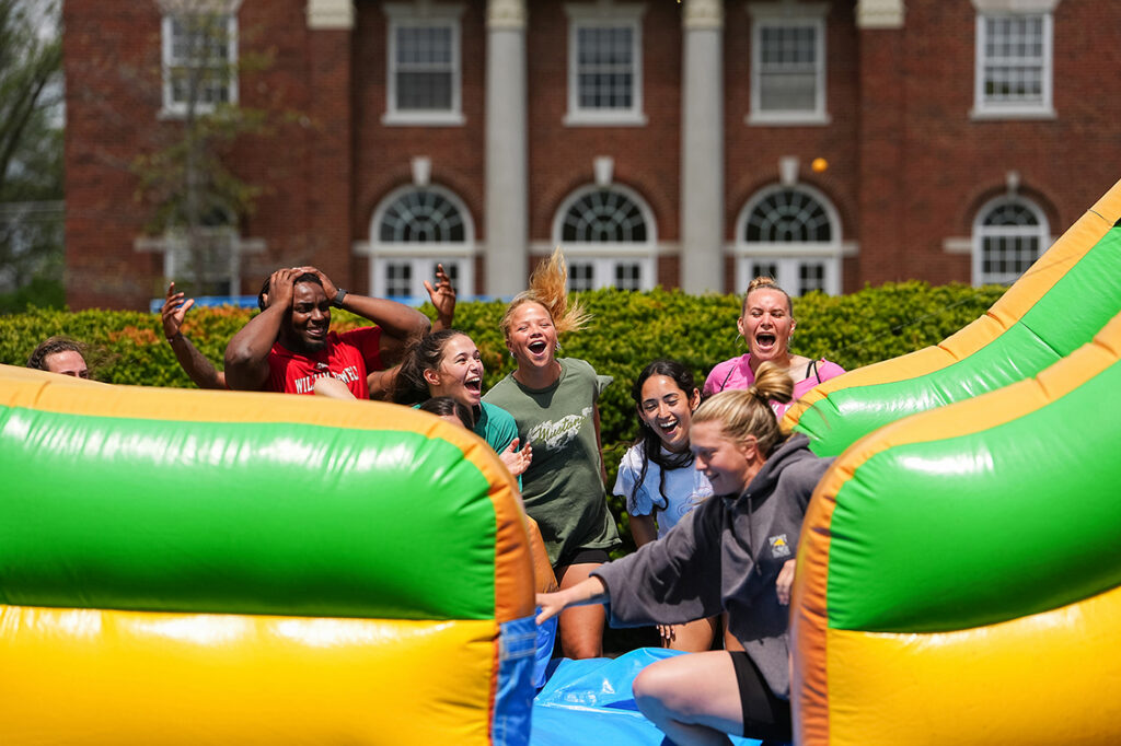 students cheering at inflatable obstacle course race